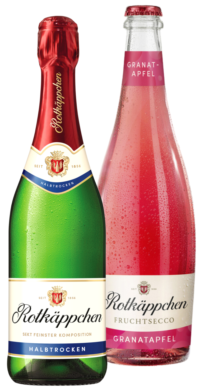 Zu sehen ist eine Glasflasche Sekt und eine Glasflasche Secco der Marke Rotkäppchen je 0,75 Liter. Die linke grüne Flasche hat ein beiges Etikett mit der Aufschrift "Rotkäppchen Sekt feinster Komposition Halbtrocken". Der Deckel und Flaschenhals sind ummantelt von einer roten Folie, auf der in querer Schrift "Rotkäppchen" geschrieben steht. Die rechte Flasche mit roter Flüssigkeit hat ein beiges Etikett mit der Aufschrift "Rotkäppchen Fruchtsecco Granatapfel". Am Flaschenhals ist ein pinkes Etikett auf dem "Granatapfel" steht.
